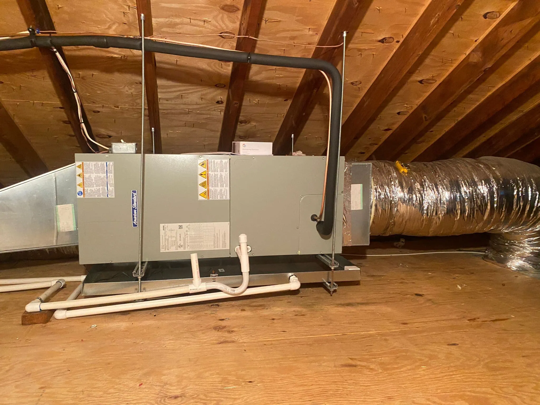 Central air conditioning unit installed in an attic space.