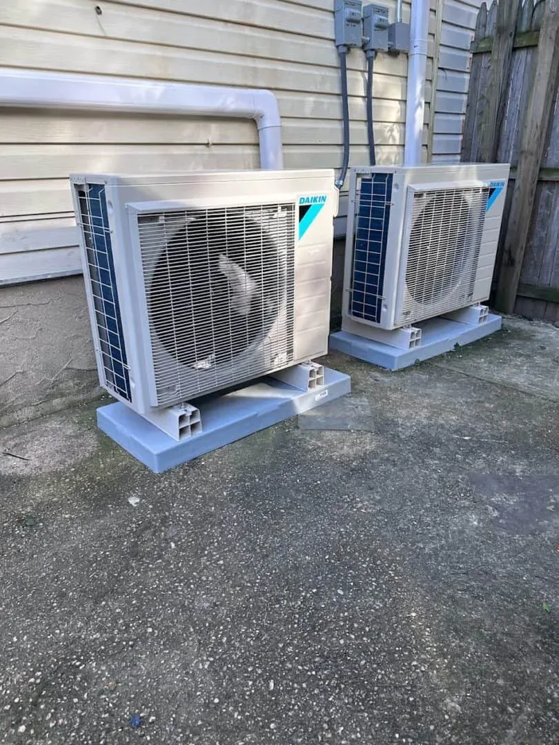 Two Daikin air conditioning units installed outdoors against a building wall.