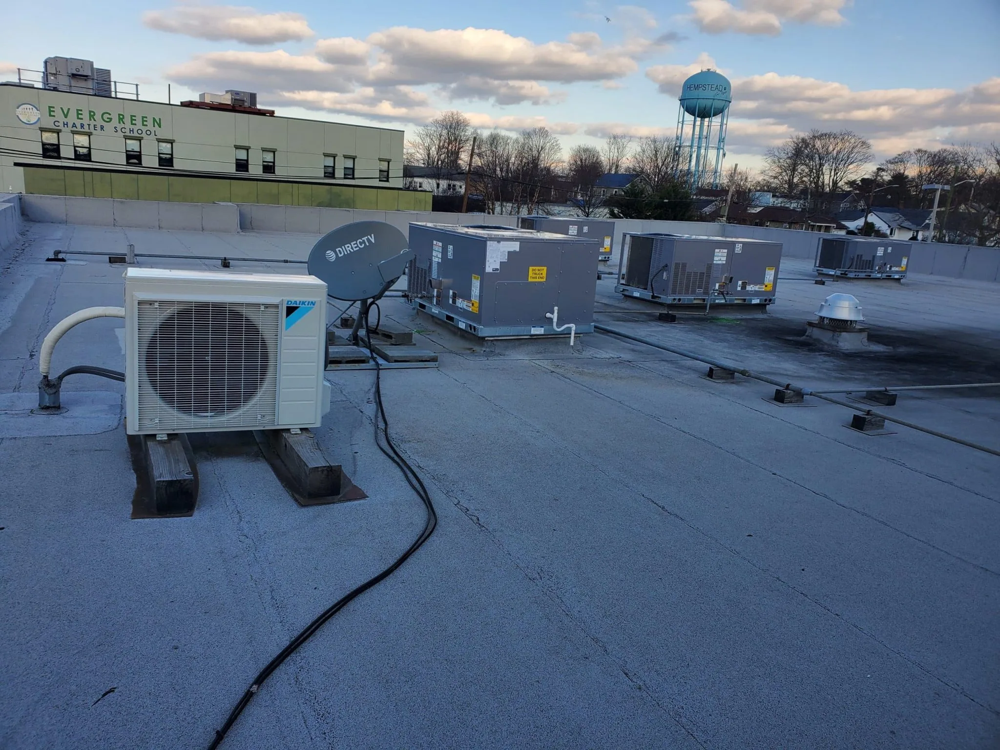 HVAC systems and satellite dish on the roof of Evergreen Charter School.
